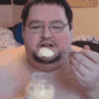 Man With Glasses And Beard Eating From Jar With Spoon GIF
