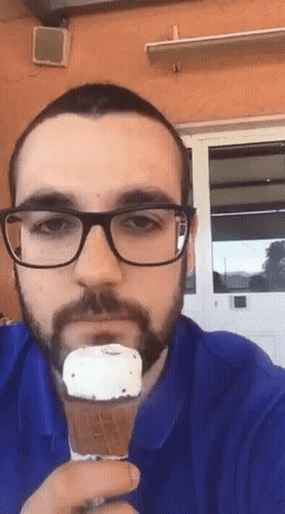 Man With Glasses And Beard Eating Ice Cream GIF