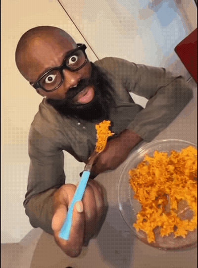 Man With Glasses And Beard Eating With Blue Spoon GIF