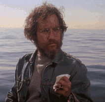 Man With Glasses And Beard Holding Paper GIF