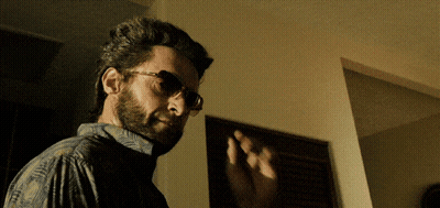 Man With Glasses And Beard In Dark Room GIF