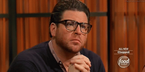 Man With Glasses And Beard In Front Of Food Network Sign GIF
