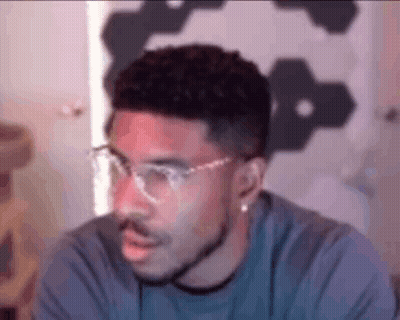 Man With Glasses And Beard Looking At Camera GIF