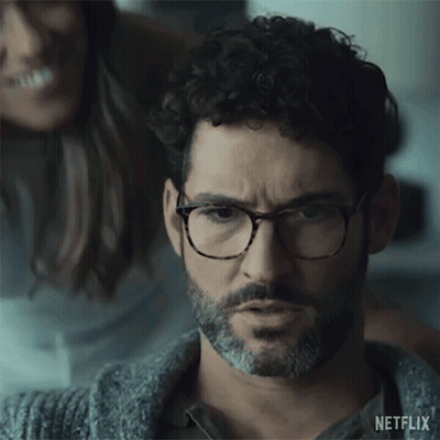 Man With Glasses And Beard Looking With Woman In Background GIF