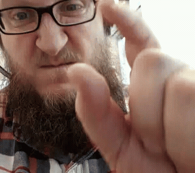 Man With Glasses And Beard Making Funny Face GIF