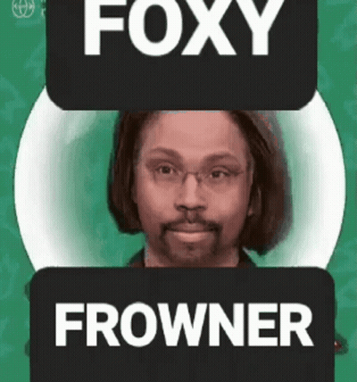 Man With Glasses And Beard Next To Foxy Frowner Sign GIF