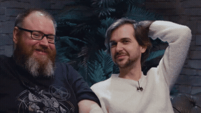 Man With Glasses And Beard Next To Man With Pentagram Shirt GIF