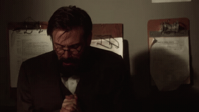 Man With Glasses And Beard Sitting By Clipboard Number 2 GIF