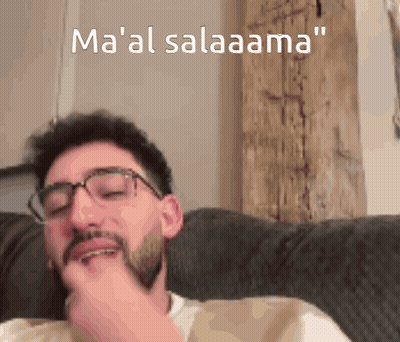 Man With Glasses And Beard Sitting On Couch Ma 'Al Salaama GIF