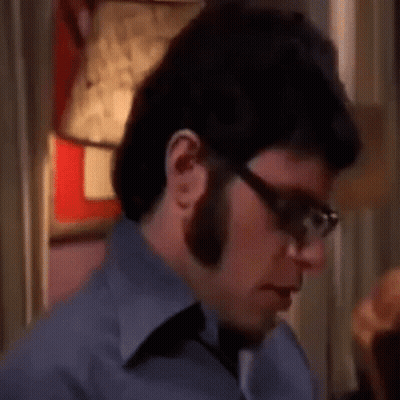 Man With Glasses And Beard Sitting GIF