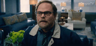 Man With Glasses And Beard Sitting With Utopiatv GIF