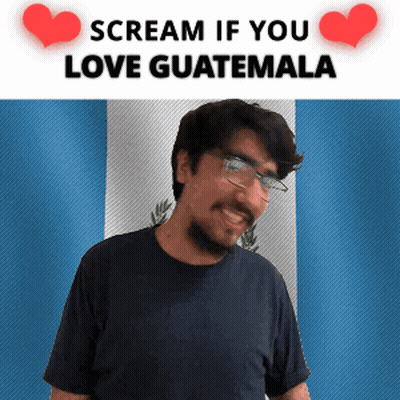 Man With Glasses And Beard Smiling In Front Of Flag Saying Scream If You Love Guatemala GIF