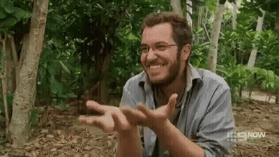 Man With Glasses And Beard Smiling In The Woods GIF
