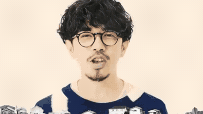 Man With Glasses And Beard Surrounded By Small Houses GIF