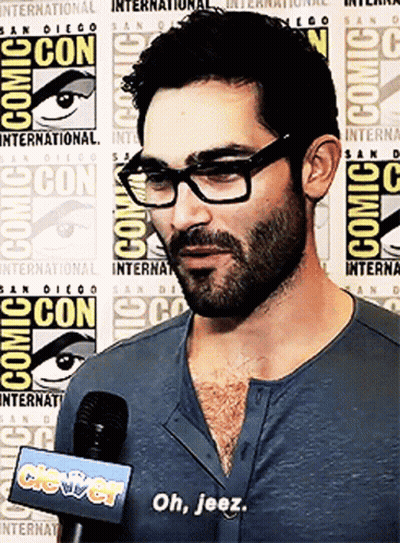 Man With Glasses And Beard Talking Into Microphone At Comic Con GIF