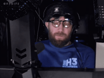 Man With Glasses And Beard Wearing Headphones And Blue Shirt GIF