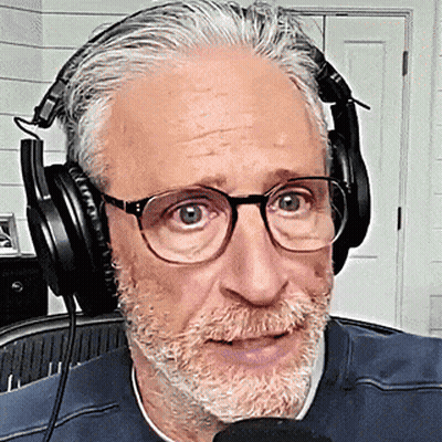 Man With Glasses And Beard Wearing Headphones Talking Into Microphone GIF
