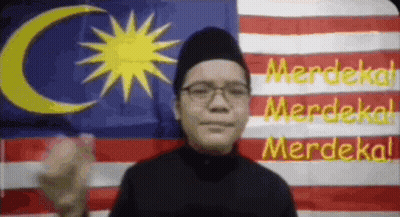 Man With Glasses And Black Hat By Malaysian Flag GIF