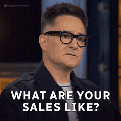 Man With Glasses And Black Jacket Saying What Are Your Sales Like GIF