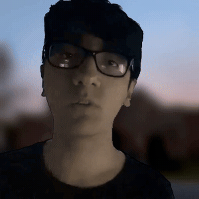 Man With Glasses And Black Shirt Looking At Camera GIF