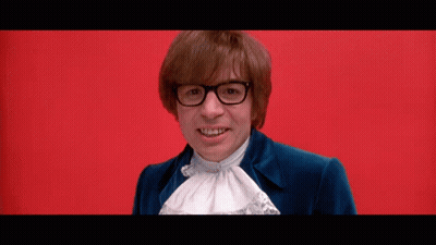 Man With Glasses And Blue Jacket Smiling On Red Background GIF