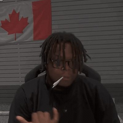 Man With Glasses And Cigarette In Front Of Canadian Flag GIF