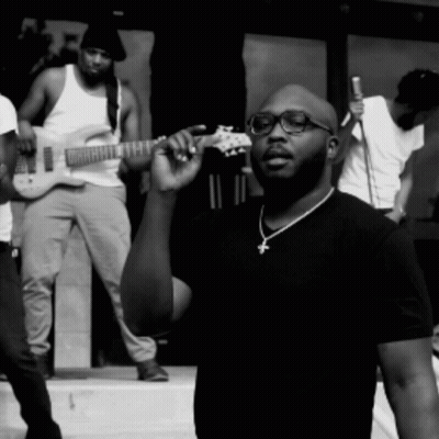 Man With Glasses And Cross Necklace Holding Guitar GIF