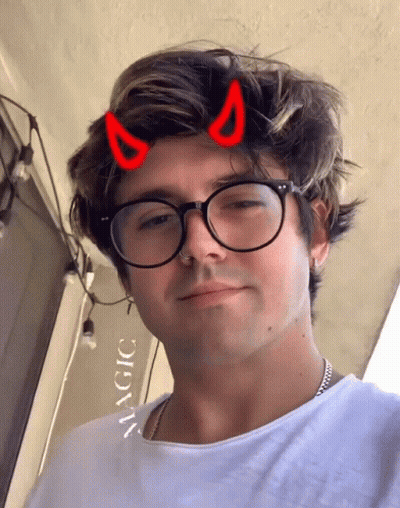 Man With Glasses And Devil Horns Saying Magic GIF