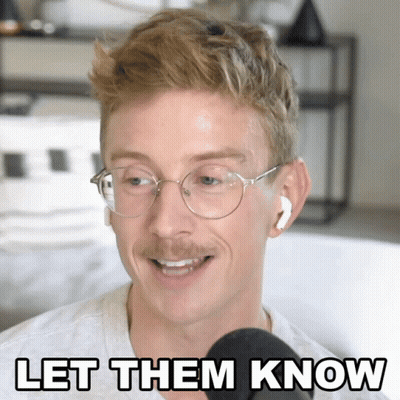 Man With Glasses And Earbuds Speaking GIF