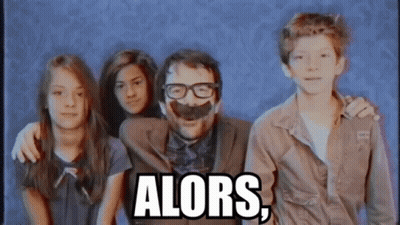 Man With Glasses And Fake Mustache Surrounded By Children Saying Alors GIF