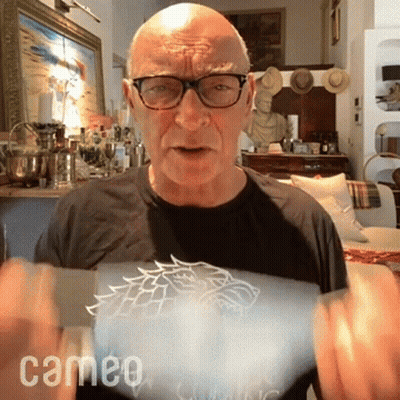 Man With Glasses And Game Of Thrones T-Shirt Holding Something GIF