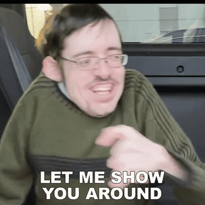 Man With Glasses And Green Sweater Saying Let Me Show You Around GIF