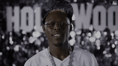 Man With Glasses And Hat In Front Of Hollywood Sign GIF