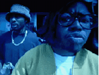 Man With Glasses And Hat Next To Man With Hat GIF