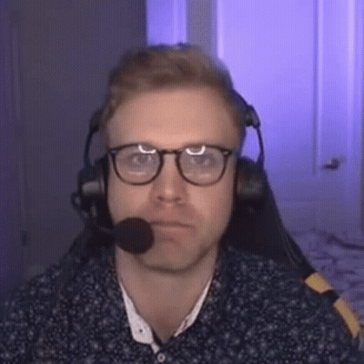 Man With Glasses and Headphones at Microphone