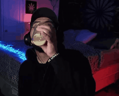 Man With Glasses And Headphones Drinking From Cup GIF