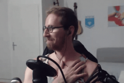 Man With Glasses And Headphones Holding Chest At Microphone GIF