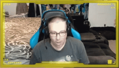 Man With Glasses And Headphones In Blue Gaming Chair GIF