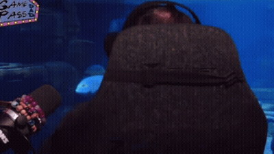 Man With Glasses And Headphones In Front Of Gang Pass Screen GIF