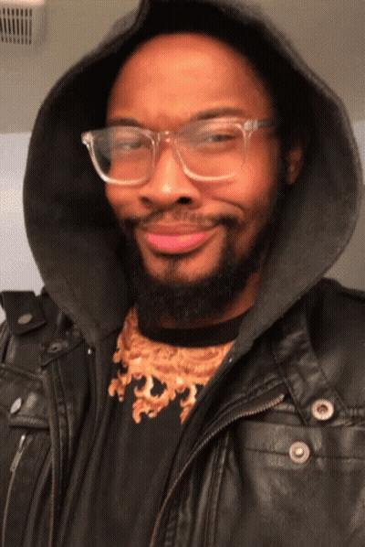 Man With Glasses And Hooded Jacket Smiling GIF