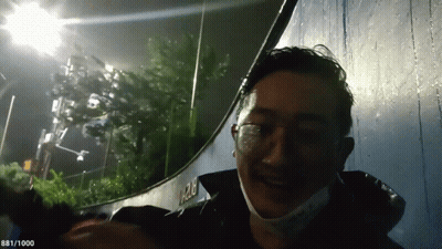 Man With Glasses And Mask Smiling Near 1282 Wall GIF