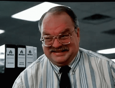 Man With Glasses And Mustache In Front Of Intech Binders GIF