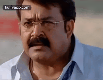 Man With Glasses And Mustache Looking At Camera GIF