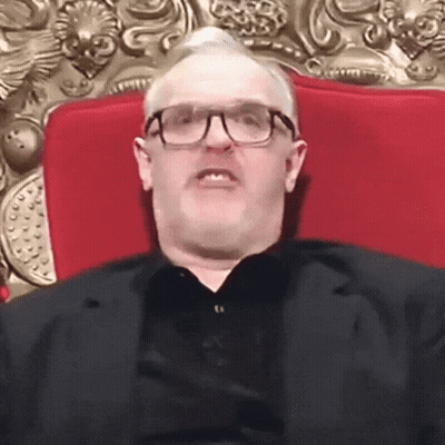 Man With Glasses And Mustache Sitting On Red Chair GIF