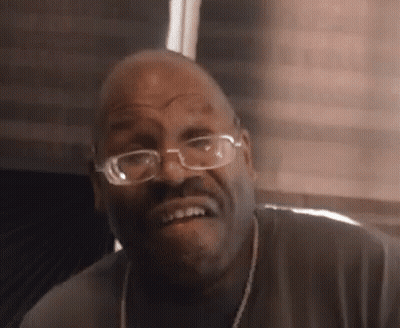 Man With Glasses And Necklace Making Funny Face GIF