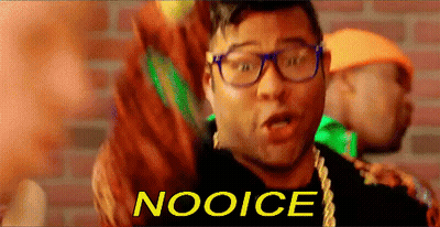 Man With Glasses And Necklace Saying Nooice In Front Of Brick Wall GIF