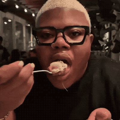 Man With Glasses and Nose Ring Eating With Spoon