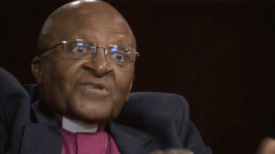 Man With Glasses And Purple Shirt Making Funny Face GIF