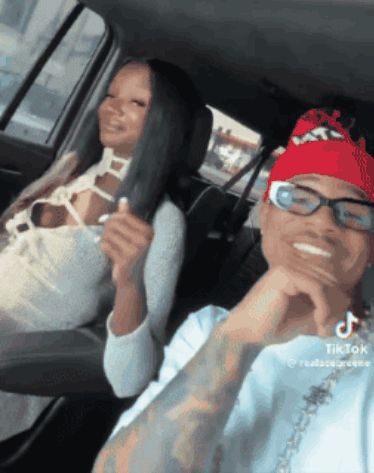 Man With Glasses And Red Bandana Next To Woman In Car GIF