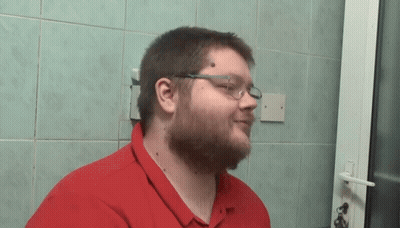 Man With Glasses And Red Shirt Standing By Door GIF